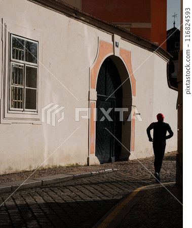 Runnin man casting long shadow. 116824593