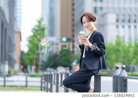 Middle-aged business woman working in an office district Middle-aged business woman working in an office district 116824661