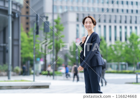 Middle-aged business woman working in an office district Middle-aged business woman working in an office district 116824668