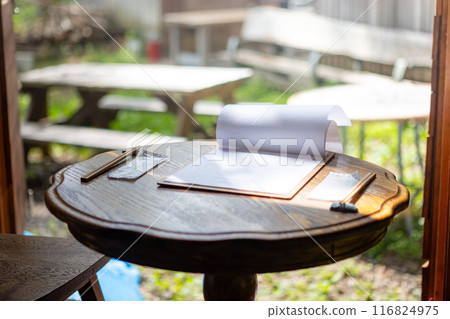 Cafe time in the sunlight filtering through the trees 116824975