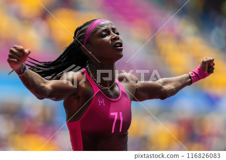 Euphoric Female Runner Celebrating Victory in Packed Stadium After Winning Championship Race 116826083