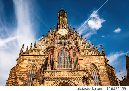 Ancient building facade Church of the Virgin Mary in old city center in Nuremberg, Germany. Historical house exterior and blue sky with clouds in Bavaria, Europe Ancient building facade Church of the Virgin Mary in old city center in Nuremberg, Germany. Historical house exterior and blue sky with clouds in Bavaria, Europe 116826469