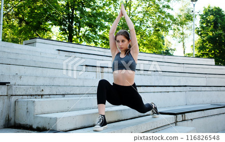 Fit Girl Doing Yoga Exercises In The Park As Part Of Morning Routine Fit Girl Doing Yoga Exercises In The Park As Part Of Morning Routine 116826548