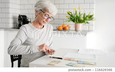Elderly Lady Tallying Cash And Coins For Utility Bill Payments 116826566