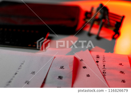 The drawing doll depicts a man sitting on a bench looking lost and at a loss, with a large number of resignation letters written incorrectly, and is illuminated in red. 116826679