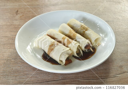 Peking roasted duck with slice cucumber and spring onion spring roll dreessing black sweet soy and chili sauce on plate 116827036