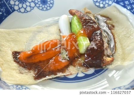 Peking roasted duck with slice cucumber and spring onion spring roll dreessing black sweet soy and chili sauce on plate 116827037