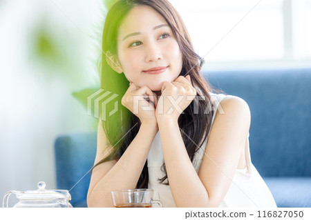 Young lady drinking tea Young lady drinking tea 116827050