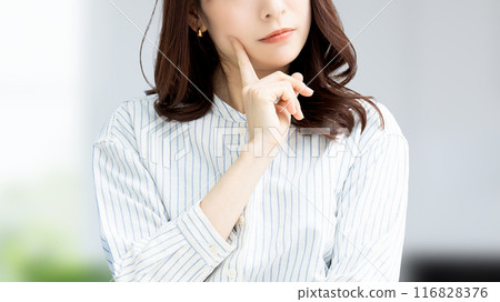 A Japanese businesswoman thinking in the office A Japanese businesswoman thinking in the office 116828376