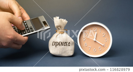 Money bag with the word Expenses. Outflow of money as payment for goods or service. The amount of the taxpayer's expenses in cash. Business concept. Man with a calculator in his hands and clock 116828979