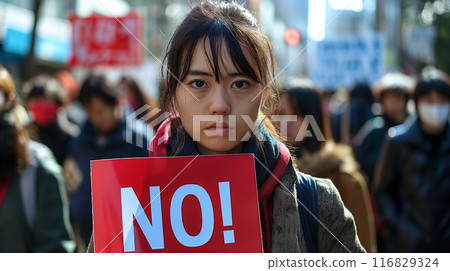 A woman holding up a NO sign 116829324