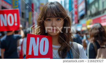 A woman holding up a NO sign 116829327