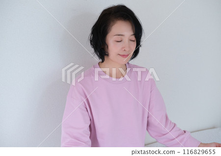 Middle-aged woman meditating to calm her mind 116829655