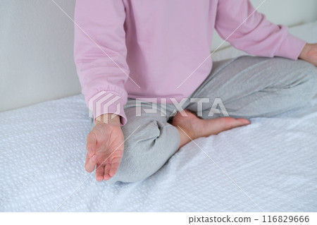 Middle-aged woman meditating to calm her mind 116829666