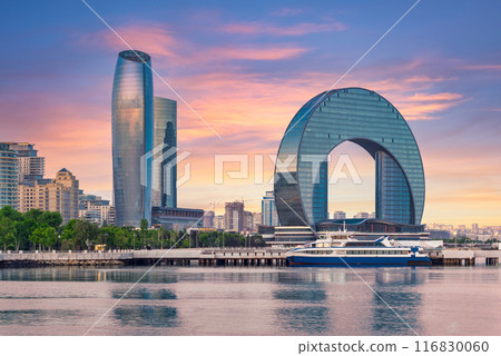 The Crescent Development Project in Baku, Azerbaijan, at sunset, with a ferry docked in the foreground The Crescent Development Project in Baku, Azerbaijan, at sunset, with a ferry docked in the foreground 116830060