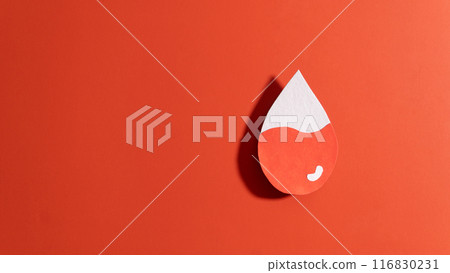 Blood drop with low blood level made from paper on red background. Concept of hematologic disorders such as anemia, sickle cell disease, hemophilia, leukemia and ITP. Blood drop with low blood level made from paper on red background. Concept of hematologic disorders such as anemia, sickle cell disease, hemophilia, leukemia and ITP. 116830231