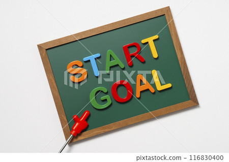 A pointer and the word START on the GOAL on a blackboard 116830400