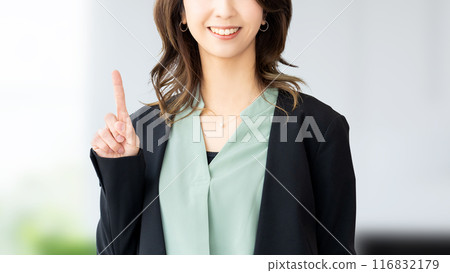 A smiling Japanese business woman who guides with her index finger up A smiling Japanese business woman who guides with her index finger up 116832179