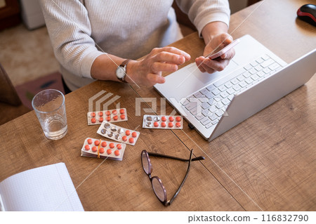 Hand of senior woman holding leaflet to prescribed medicine Hand of senior woman holding leaflet to prescribed medicine 116832790