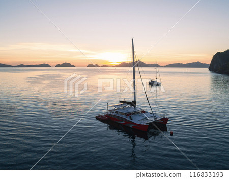 Aerial of a catamaran moored at sunset in the Philippines Aerial of a catamaran moored at sunset in the Philippines 116833193