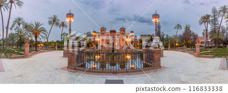Old building in Moorish style and a pond in front of it in a park in Seville, Spain 116833338