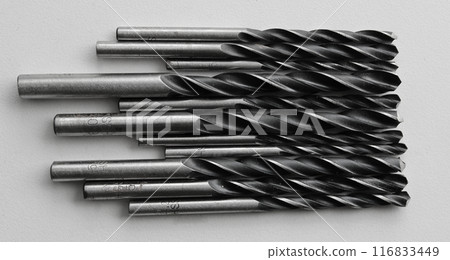 Evenly laid out adjacent drill bits for an electric drill. Stock photo for perforating and drilling illustration 116833449