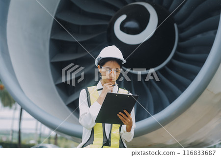 Technician fixing the engine of the airplane,Female aerospace engineering checking aircraft engines,Asian mechanic maintenance inspects plane engine 116833687
