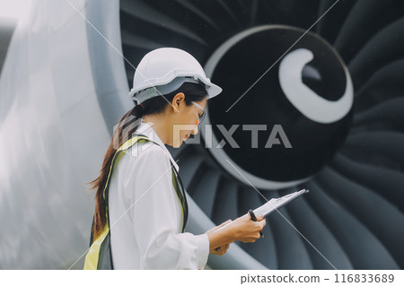 Technician fixing the engine of the airplane,Female aerospace engineering checking aircraft engines,Asian mechanic maintenance inspects plane engine 116833689