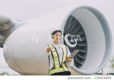 Technician fixing the engine of the airplane,Female aerospace engineering checking aircraft engines,Asian mechanic maintenance inspects plane engine 116833693
