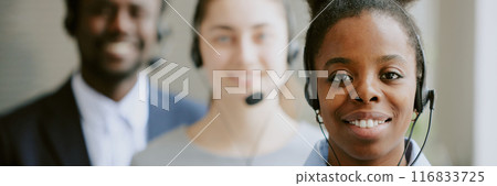 Website header demonstrating first class call center specialists looking at camera and smiling 116833725