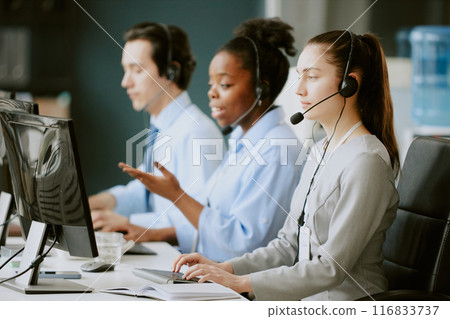 Team of young biracial operators having callsat work in office of modern company 116833737