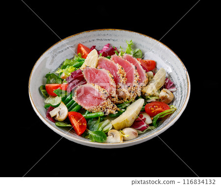 Salad with tuna and artichokes on a black background for the restaurant menu Salad with tuna and artichokes on a black background for the restaurant menu 116834132