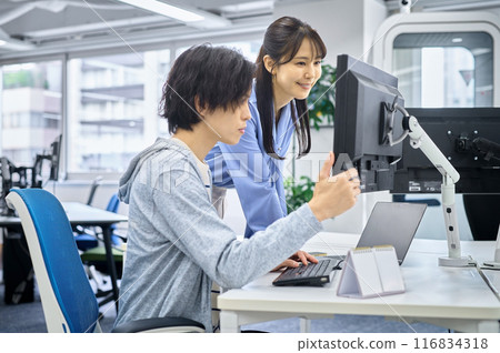 Male and female engineers in plain clothes working in the office Male and female engineers in plain clothes working in the office 116834318