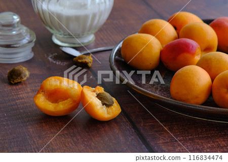 yellow ripe apricots on a plate 116834474