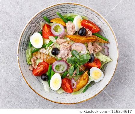 Tuna salad on a gray background. Nicoise salad, for restaurant menu for delivery Tuna salad on a gray background. Nicoise salad, for restaurant menu for delivery 116834617