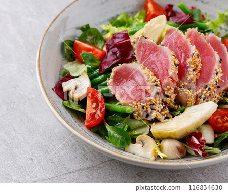 Tuna salad on a gray background. Nicoise salad, for restaurant menu for delivery 116834630