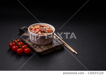 Delicious asian udon dish with vegetables, meat, salt and spices Delicious asian udon dish with vegetables, meat, salt and spices 116835120