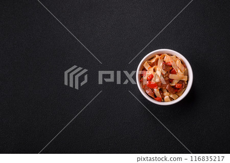 Delicious asian udon dish with vegetables, meat, salt and spices Delicious asian udon dish with vegetables, meat, salt and spices 116835217