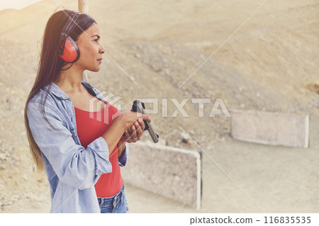 Woman releasing stress, Instructor helping woman with gun Woman releasing stress, Instructor helping woman with gun 116835535