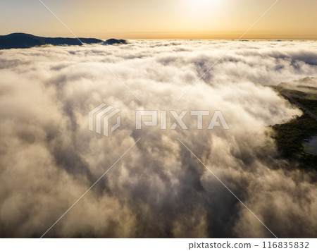Aerial view of sunset above clouds on Madeira island, Portugal Aerial view of sunset above clouds on Madeira island, Portugal 116835832