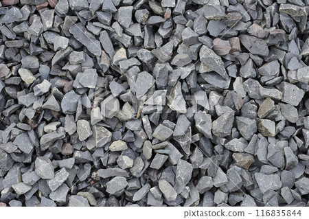 Quarry rubble. Crushed stone close up. Small rocks ground. Road building material and granite texture. Construction and road-making material. Garden blue stone gravel. Road base for pathway, driveway 116835844