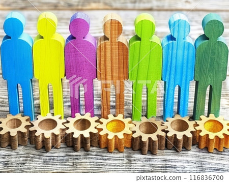Diverse team standing on gears representing successful teamwork 116836700