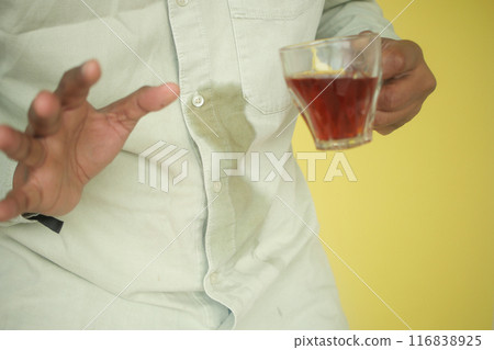 men hands with spilled coffee over his shirt men hands with spilled coffee over his shirt 116838925