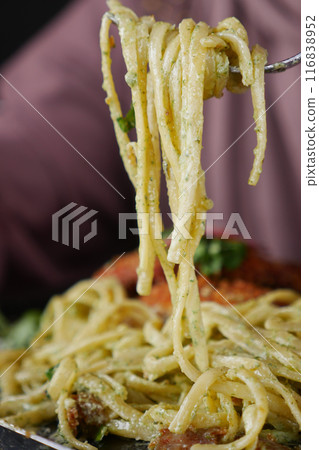 CloseUp of a Fork with Spaghetti in a Charming Italian Restaurant Setting CloseUp of a Fork with Spaghetti in a Charming Italian Restaurant Setting 116838952
