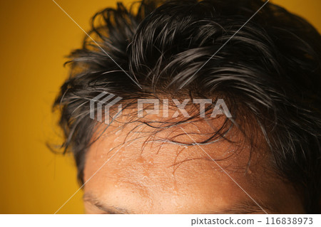 closeup of sweat on forehead against dark background , 116838973