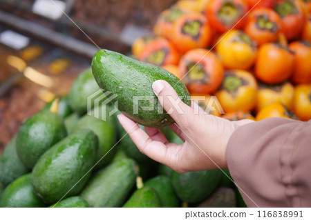 young woman hand holding avocado shopping at retail store young woman hand holding avocado shopping at retail store 116838991