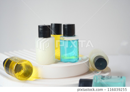 Assortment of Small Bottles with Skincare and Spa Products on Clean White Background 116839255