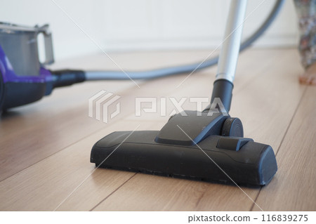 cleaning floor dust with vacuum cleaner. cleaning floor dust with vacuum cleaner. 116839275