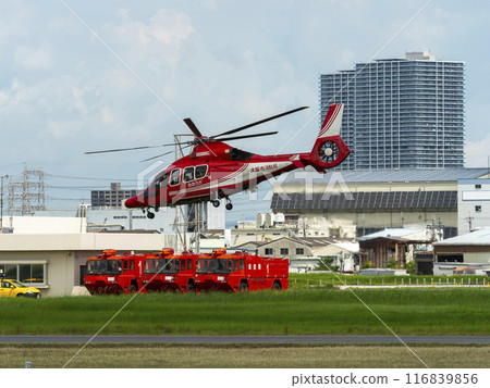 A firefighting helicopter and airport chemical fire engine taking off from Yao Airport 116839856