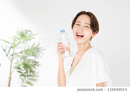 A woman drinking water A woman drinking water 116840014